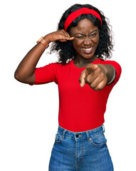 Beautiful african young woman wearing casual clothes smiling doing talking on the telephone gesture...
