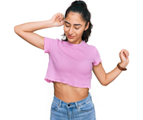 Hispanic teenager girl with dental braces wearing casual clothes stretching back, tired and relaxed, sleepy and yawning for early morning