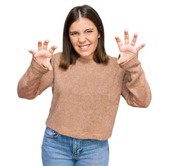 Young beautiful woman wearing casual clothes smiling funny doing claw gesture as cat, aggressive...
