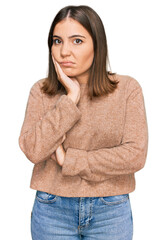 Young beautiful woman wearing casual clothes thinking looking tired and bored with depression problems with crossed arms.