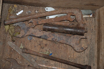 Box with old tools. In a wooden box at the bottom there are several wrenches, socket wrenches and...