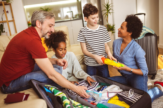 Happy family having great time and packing for summer holidays
