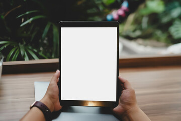 Mockup image of woman's hand holding black tablet pc with blank white screen at office.
