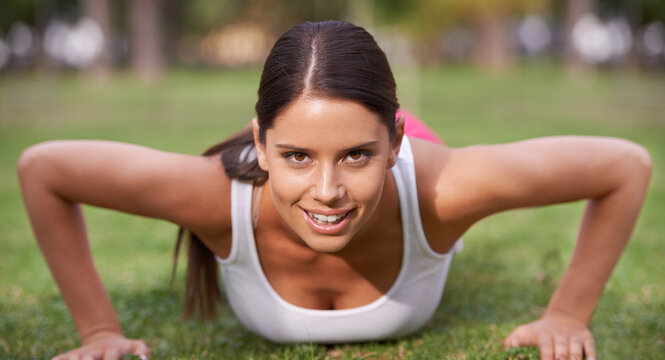 Push up, park or portrait of woman in fitness training, exercise or workout for wellness, routine or balance. Ready, smile or happy athlete on grass for strong arm muscles, activity or body mobility
