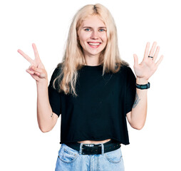 Fototapeta na wymiar Young caucasian woman wearing casual clothes showing and pointing up with fingers number seven while smiling confident and happy.