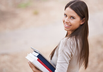 Fototapeta premium Student, portrait and books with tablet in nature, technology and education for learning at university. Park, young woman and face by happy connection, college and commitment with networking online