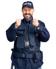 Young handsome man wearing police uniform excited for success with arms raised and eyes closed celebrating victory smiling. winner concept.