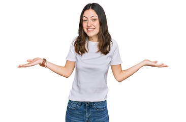 Young beautiful woman wearing casual white t shirt smiling showing both hands open palms, presenting and advertising comparison and balance