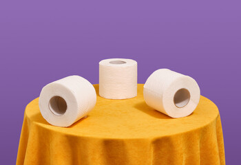 Three rolls of soft white toilet paper. Cleaning and hygiene.