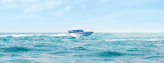 Big and luxury speedboat moving in the sea. Thai excursion vessel. - obrazy, fototapety, plakaty
