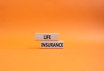 Life insurance symbol. Concept word Life insurance on wooden blocks. Beautiful orange background. Business and Life insurance concept. Copy space - obrazy, fototapety, plakaty