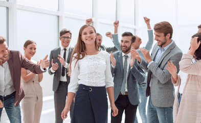 happy young businesswoman standing in the circle of her colleagues