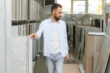 Man choosing tiles at building market