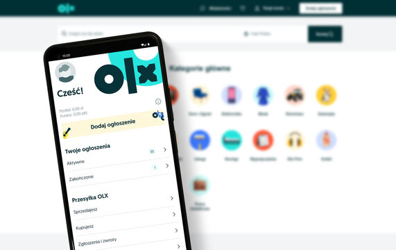 olx mobile app on smartphone in front of desktop screen with website platform - Warsaw, Poland - 16.01.2024