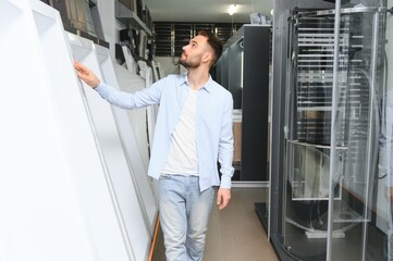 Young man choosing a bath and bath sink