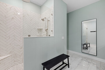 a modern bathroom has white and light blue walls and tile flooring