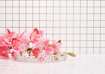 A sparkling tiara with stones and spring beautiful flowers. Copy space for text.