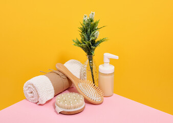 Beauty concept. Clean white shower towel, wooden comb, massage brush and gel.