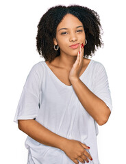 Fototapeta na wymiar Young african american girl wearing casual clothes touching mouth with hand with painful expression because of toothache or dental illness on teeth. dentist