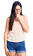 Fototapeta premium Young beautiful caucasian woman wearing casual clothes and glasses feeling unwell and coughing as symptom for cold or bronchitis. health care concept.