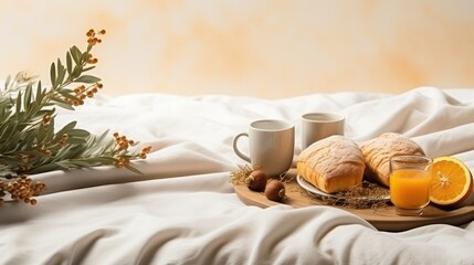  a tray with bread, oranges, and a cup of coffee on a bed with a white comforter.