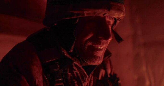 Portrait of a Ukrainian chaplain in a dugout. Close-up of vee in the dark dugout.