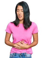 Fototapeta premium Beautiful asian young woman wearing casual pink t shirt with hand on stomach because nausea, painful disease feeling unwell. ache concept.