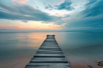 Wooden pier on the sea at sunset. Long exposure photography.