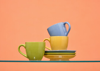 Brightly colored cups and plates. Set of clean washed tableware.