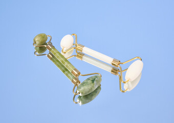 Green and white roller facial massager on the mirror. Massage and spa products.