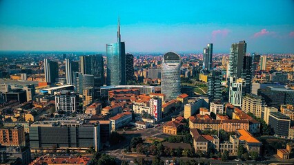 Aerial view of modern stylish cityscape of business skyscrapers. unicredit tower and UnipolSai, Microsoft Italia. Skyline. Drone. Sunny day and blue sky. Fashion city. Europe Italy Milan 01.2024