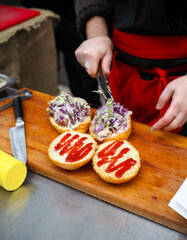 Chef making beef burgers outdoor on open kitchen
