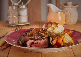 Sliced venison with creamy mashed potatoes,roasted vegetables and a rich mushroom and onion gravy.