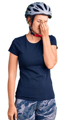 Beautiful caucasian woman wearing bike helmet tired rubbing nose and eyes feeling fatigue and headache. stress and frustration concept.