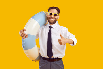 Portrait of a young happy man in sunglasses and with rubber ring wearing office clothes showing...