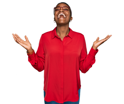 Young african american woman wearing casual clothes and glasses celebrating mad and crazy for success with arms raised and closed eyes screaming excited. winner concept