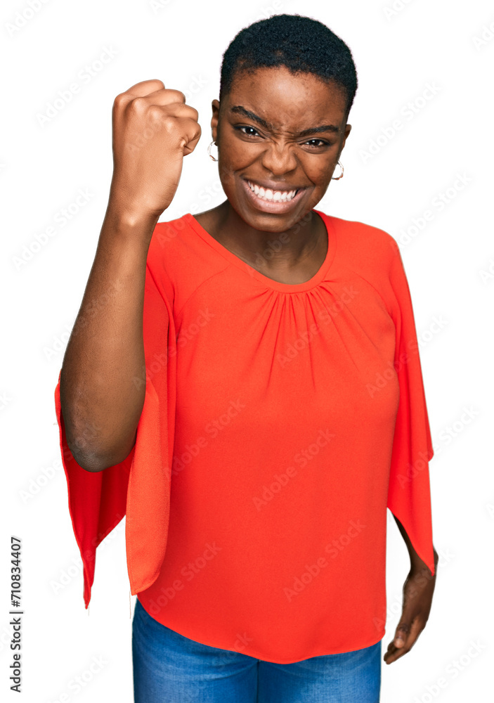 Sticker young african american woman wearing casual clothes angry and mad raising fist frustrated and furiou