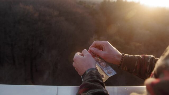 Ripping of a package of microdosing truffles during a golden hour sunset