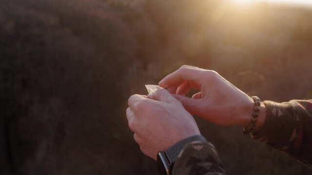 Opening a package of microdosing truffles during a golden hour sunset