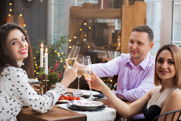 Friends toasting with champagne during dinner