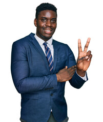 Handsome business black man wearing business suit and tie smiling with happy face winking at the camera doing victory sign. number two.