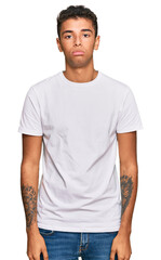 Obraz premium Young handsome african american man wearing casual white tshirt depressed and worry for distress, crying angry and afraid. sad expression.