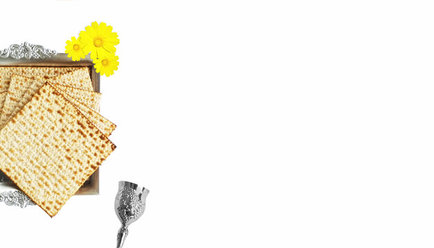 Matza in a silver plate, with a silver cup for Kiddush and yellow flowers. Passover elements for a blessing and a greeting card. top view of matza,
jewish Passover (Pesach)
with free space for text