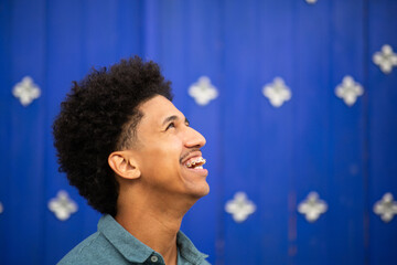 side portrait smiling young man with afro