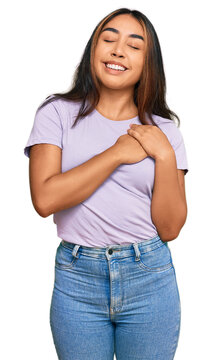 Young latin woman wearing casual clothes smiling with hands on chest with closed eyes and grateful gesture on face. health concept.
