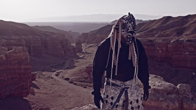 A masked shaman at the top of the canyon./ A masked shaman at the top of the canyon.