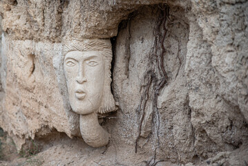 outdoor sculpted figure of human face on the wall by anonymous sculptor in Falces Navarra