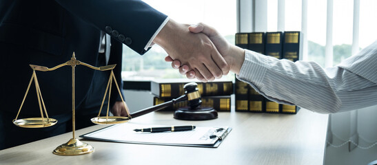 Handshake after consultation between a male lawyer and client, giving advice and prosecutions about...
