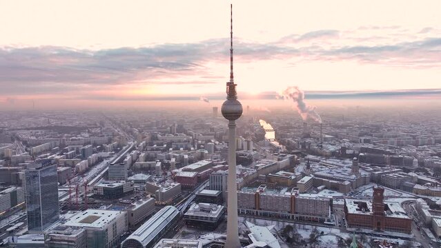 City of Berlin, Germany from above. Aerial winter cityscape view at sunrise or sunset, showing architectural landmarks Oberbaum Bridge, TV Tower and Berlin Cathedral in winter. 