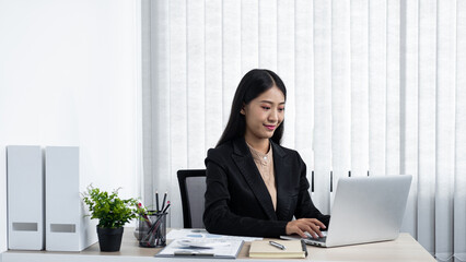 Young secretary woman checking her boss's meeting to typing emai